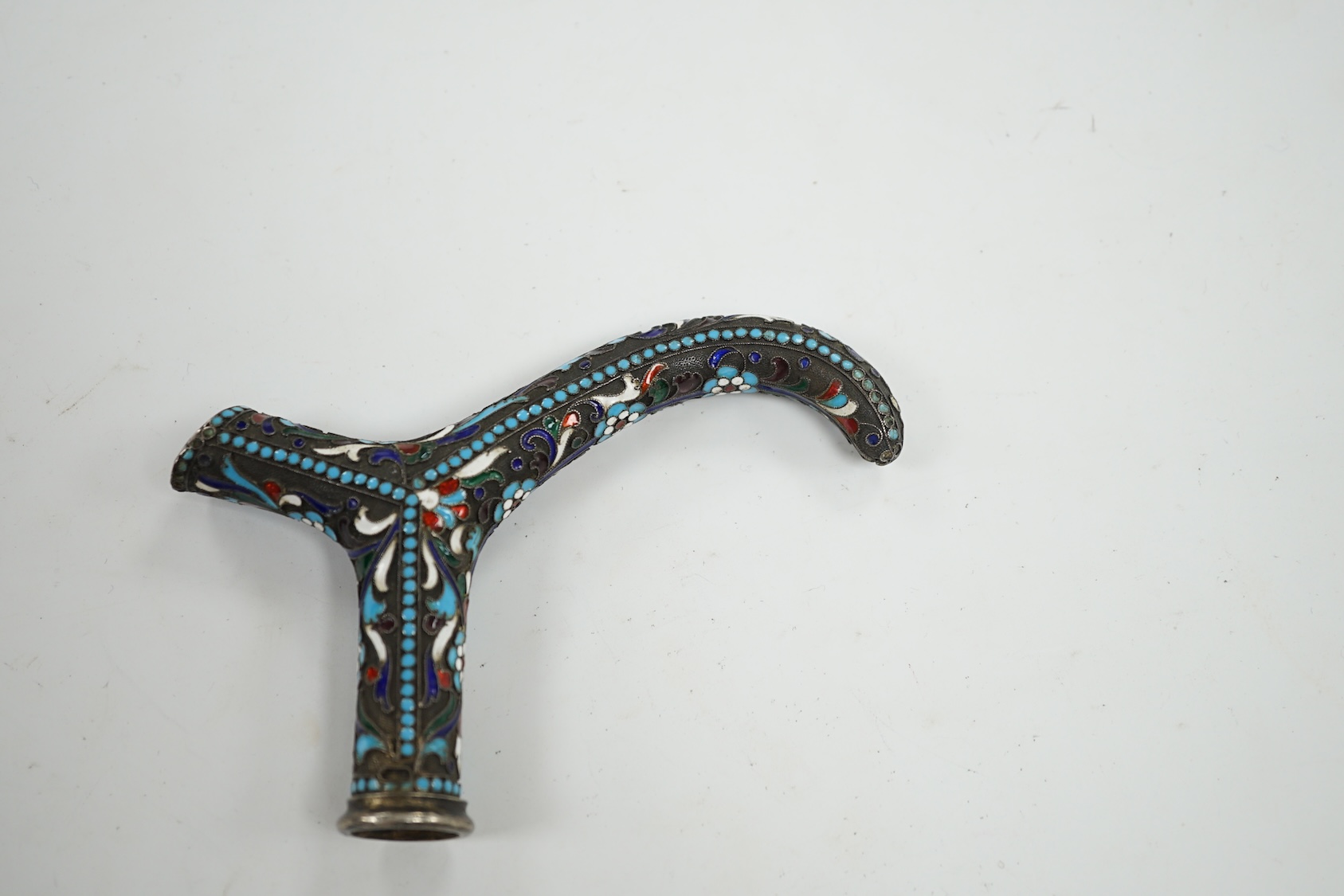 A Russian white metal and enamel walking stick handle, 12cm wide. Condition - fair to good